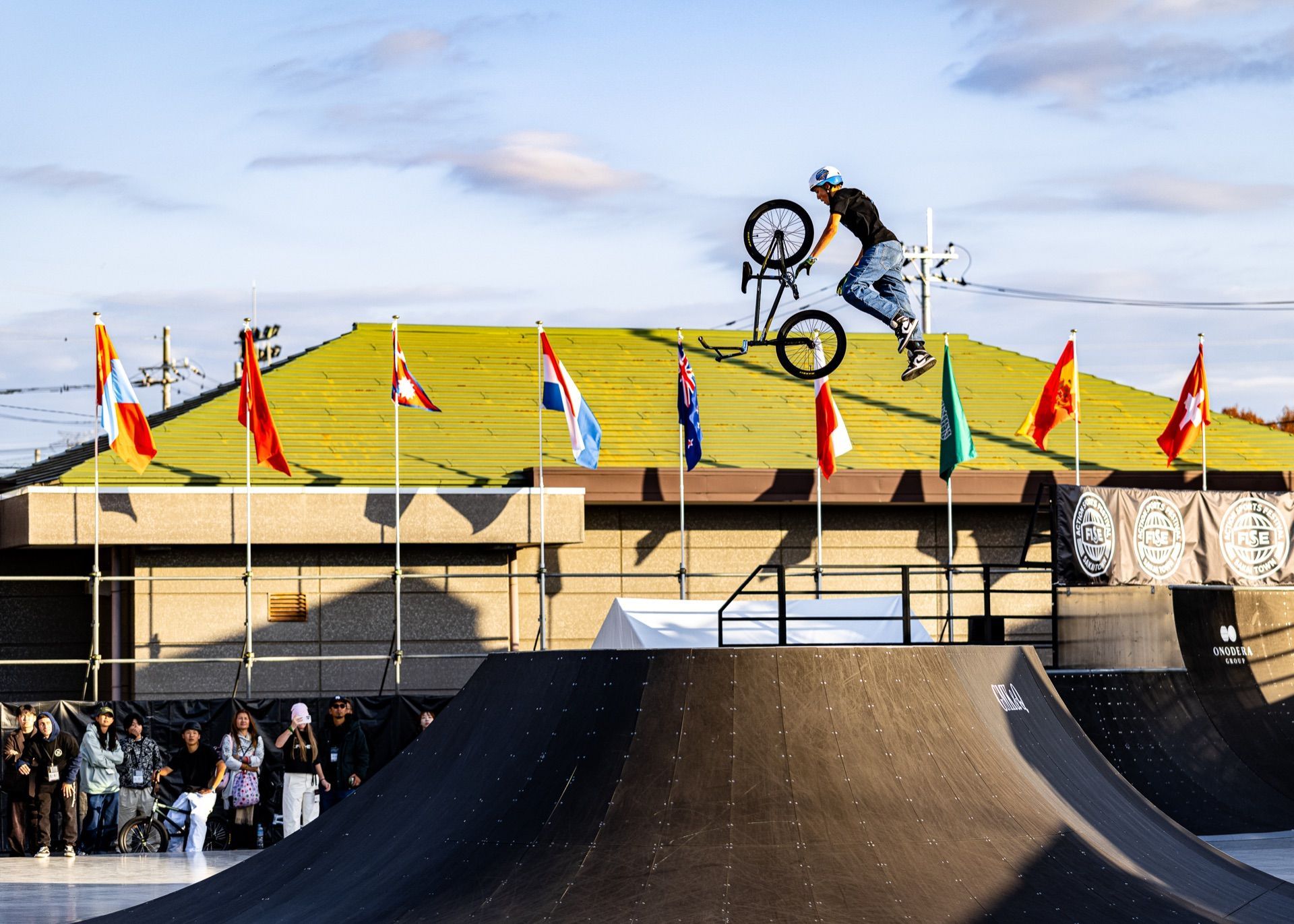 BMX rider airborne above an international competition course