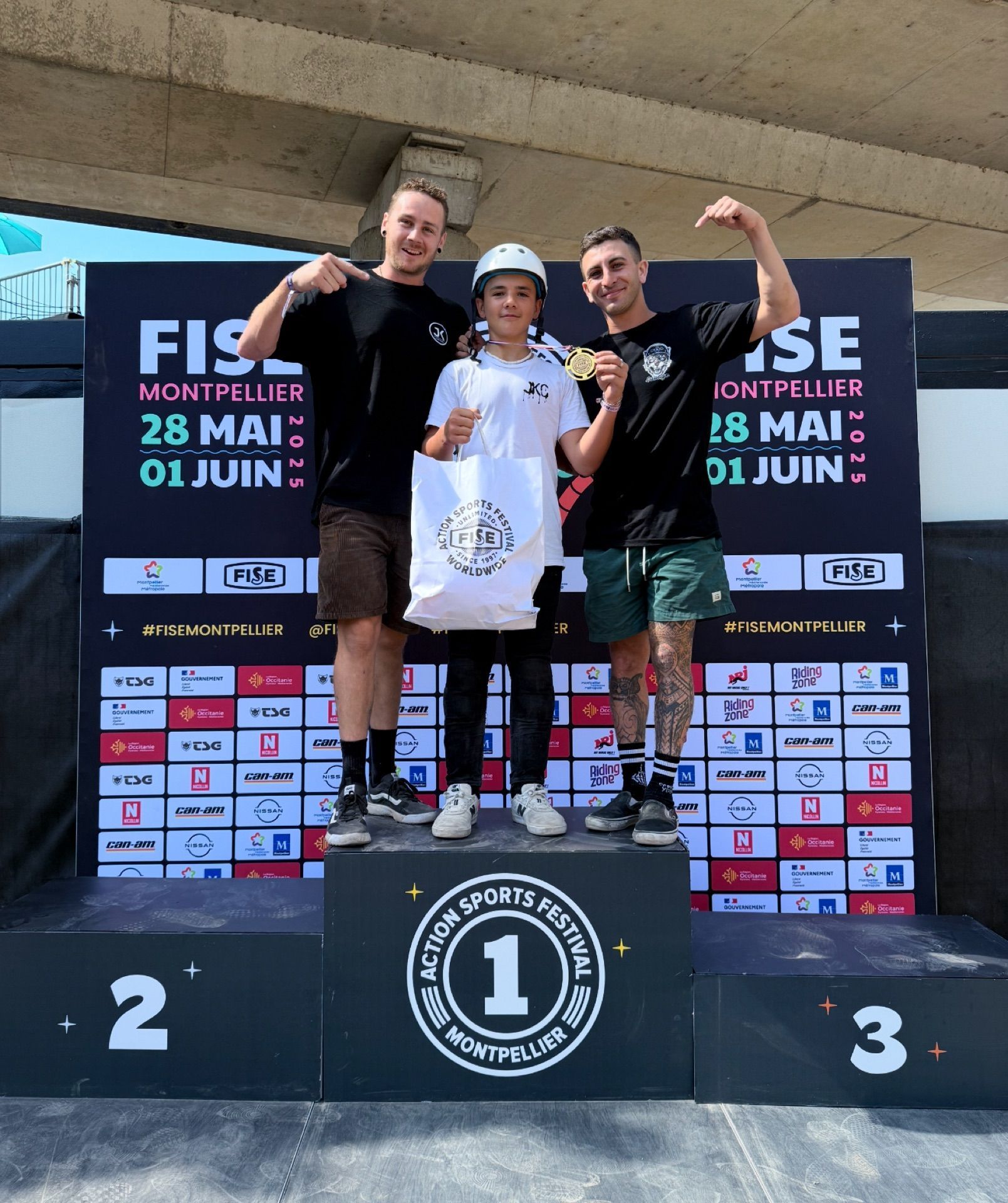 JKC rider and coaches celebrating on the FISE podium