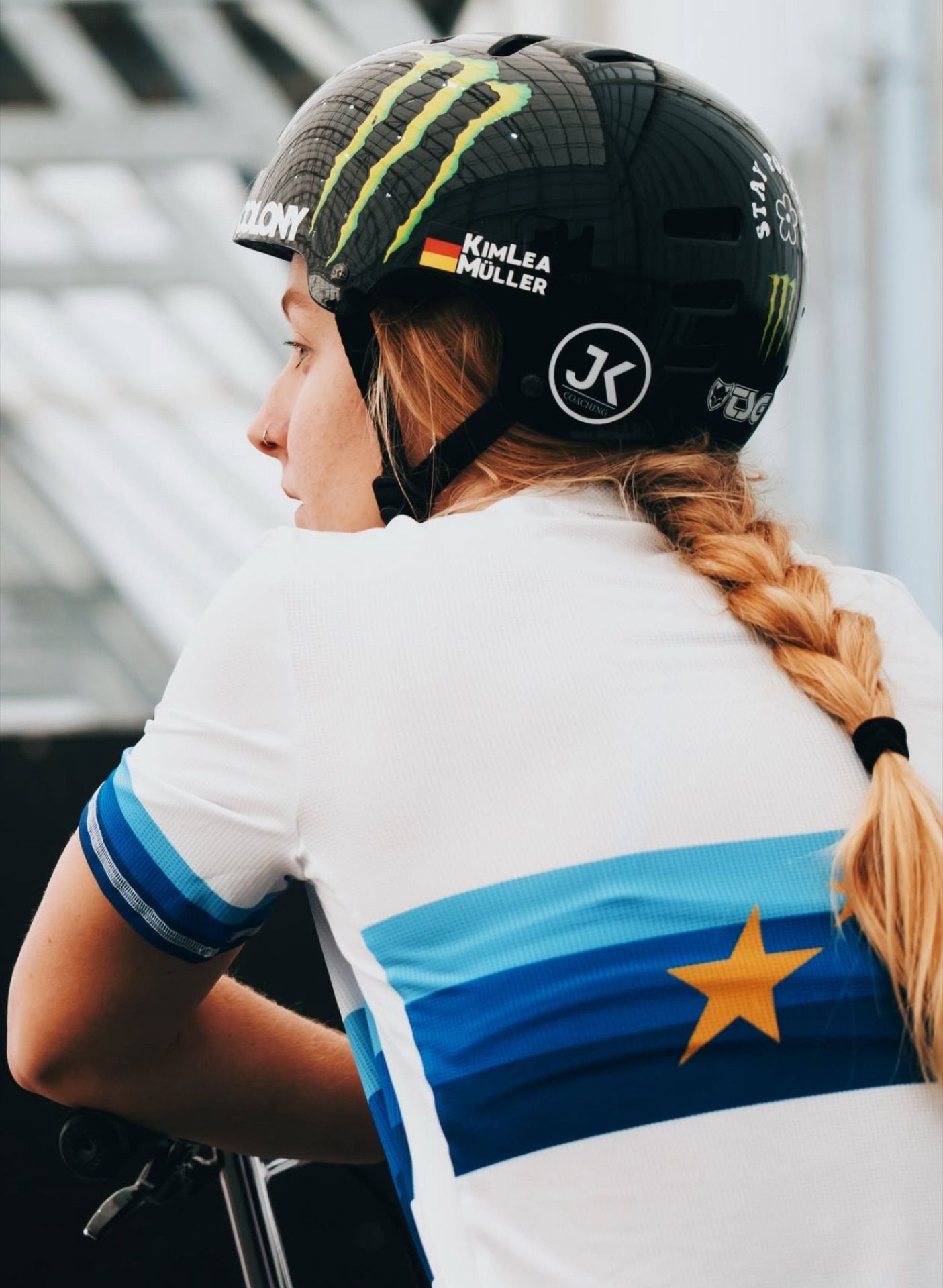BMX rider wearing a helmet with the JK Coaching logo