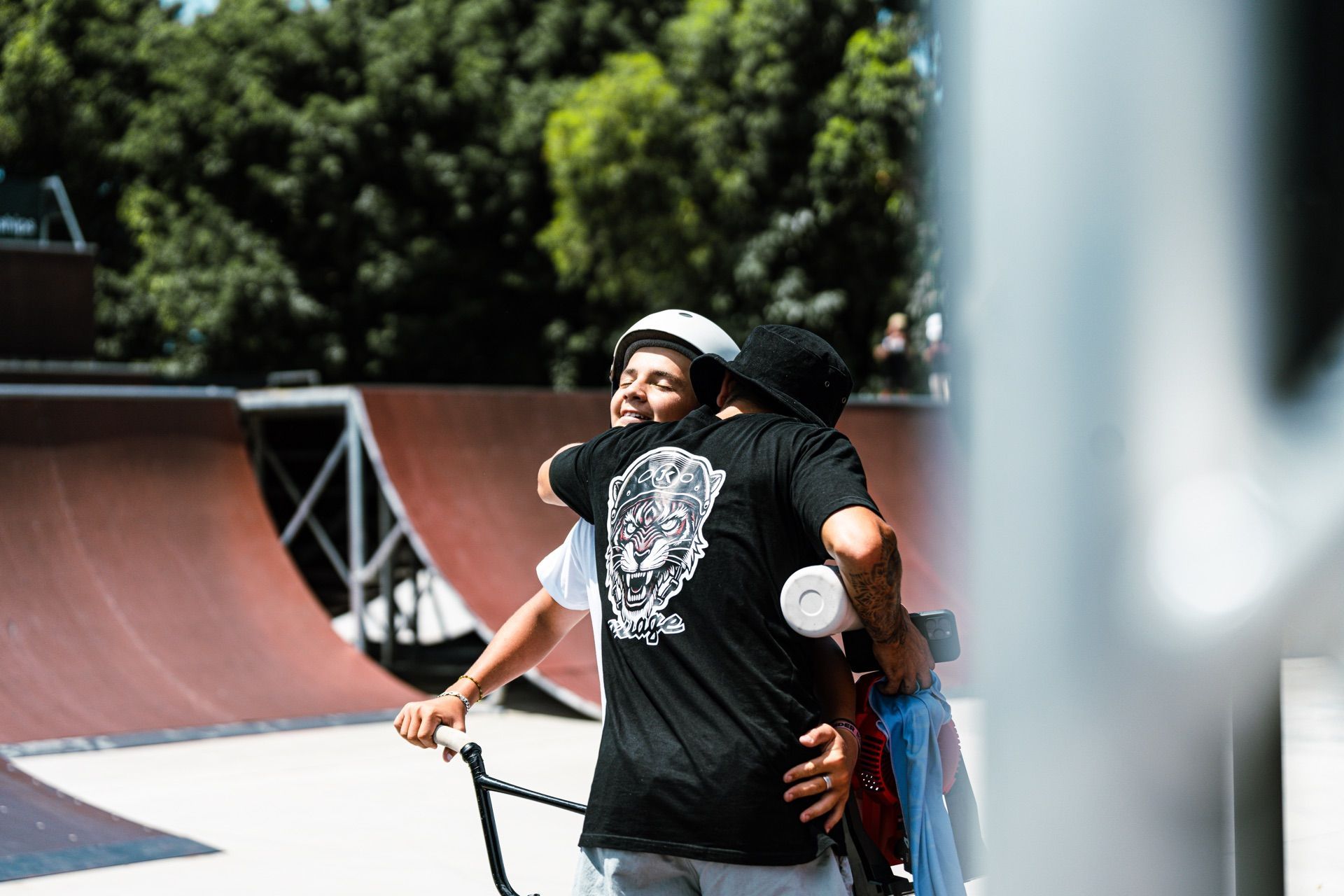 Coach embracing a rider at the skatepark