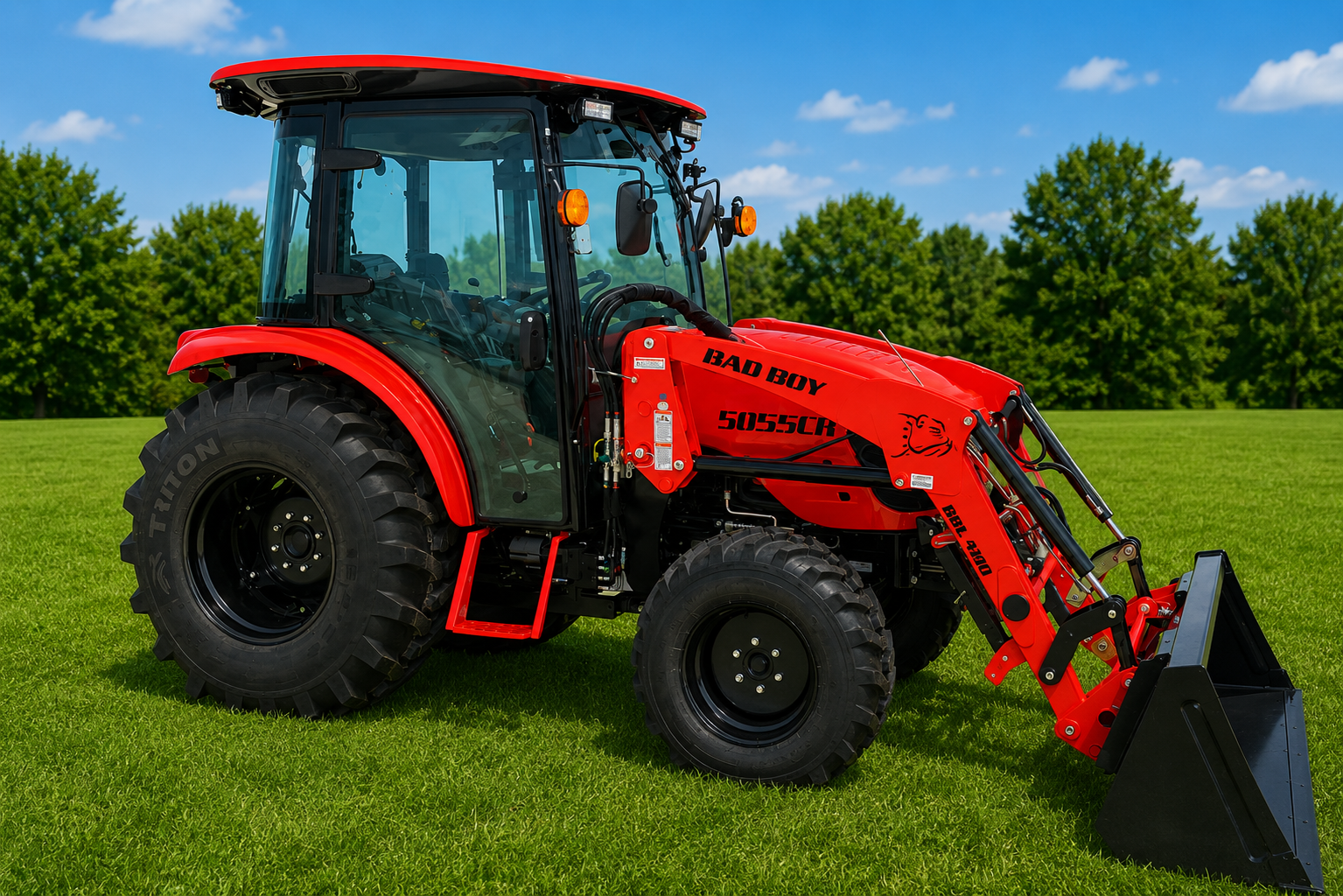 Red tractor with front loader on green grass, with trees in the background.