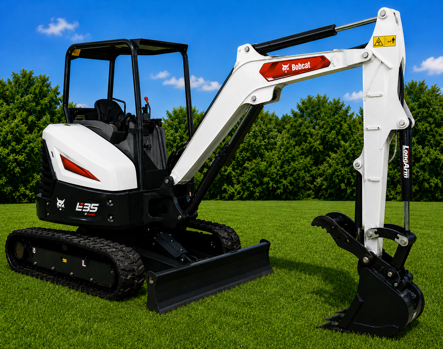 Compact white-and-black mini excavator on grass with a raised digging arm and bucket under a blue sky.