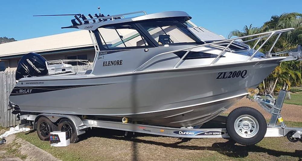 A Silver Boat is Parked on a Trailer in Front of a Building — Seabourne Electronics PTY Ltd in Railway Estate, QLD