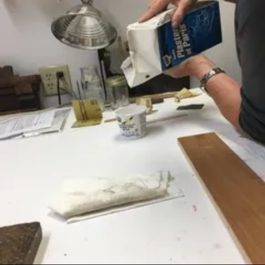 A person is holding a book titled practical physics