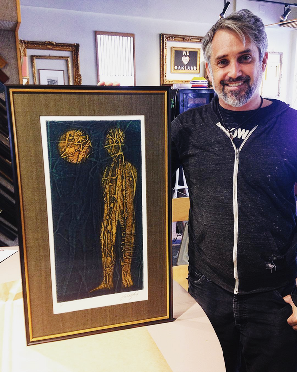 Galleria Scola client holding framed picture