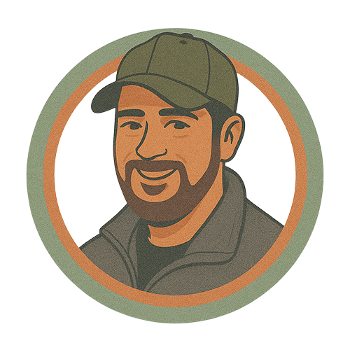 A man with a beard is wearing a baseball cap and smiling.
