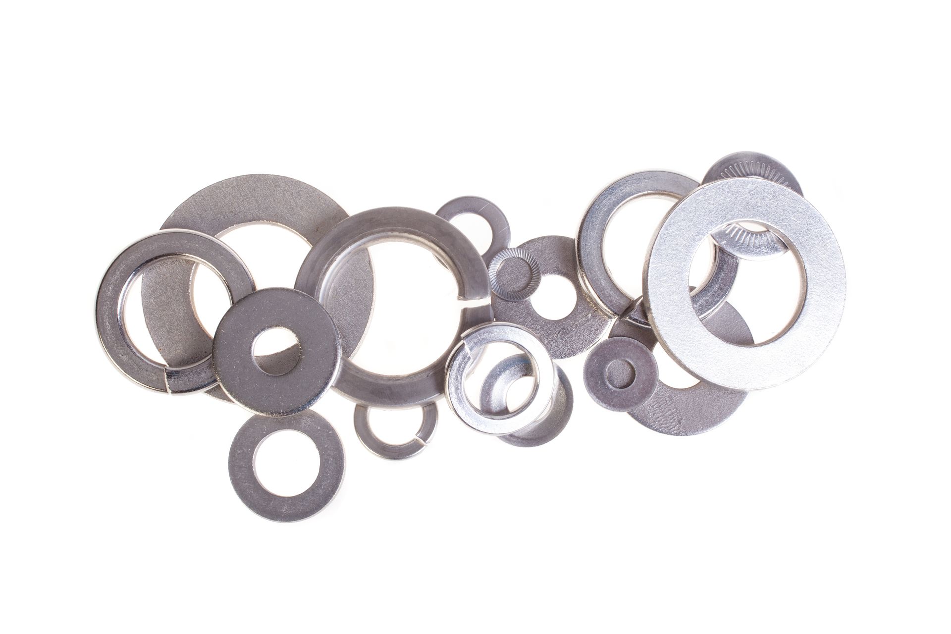 Assorted metallic rings and washers arranged on a white background