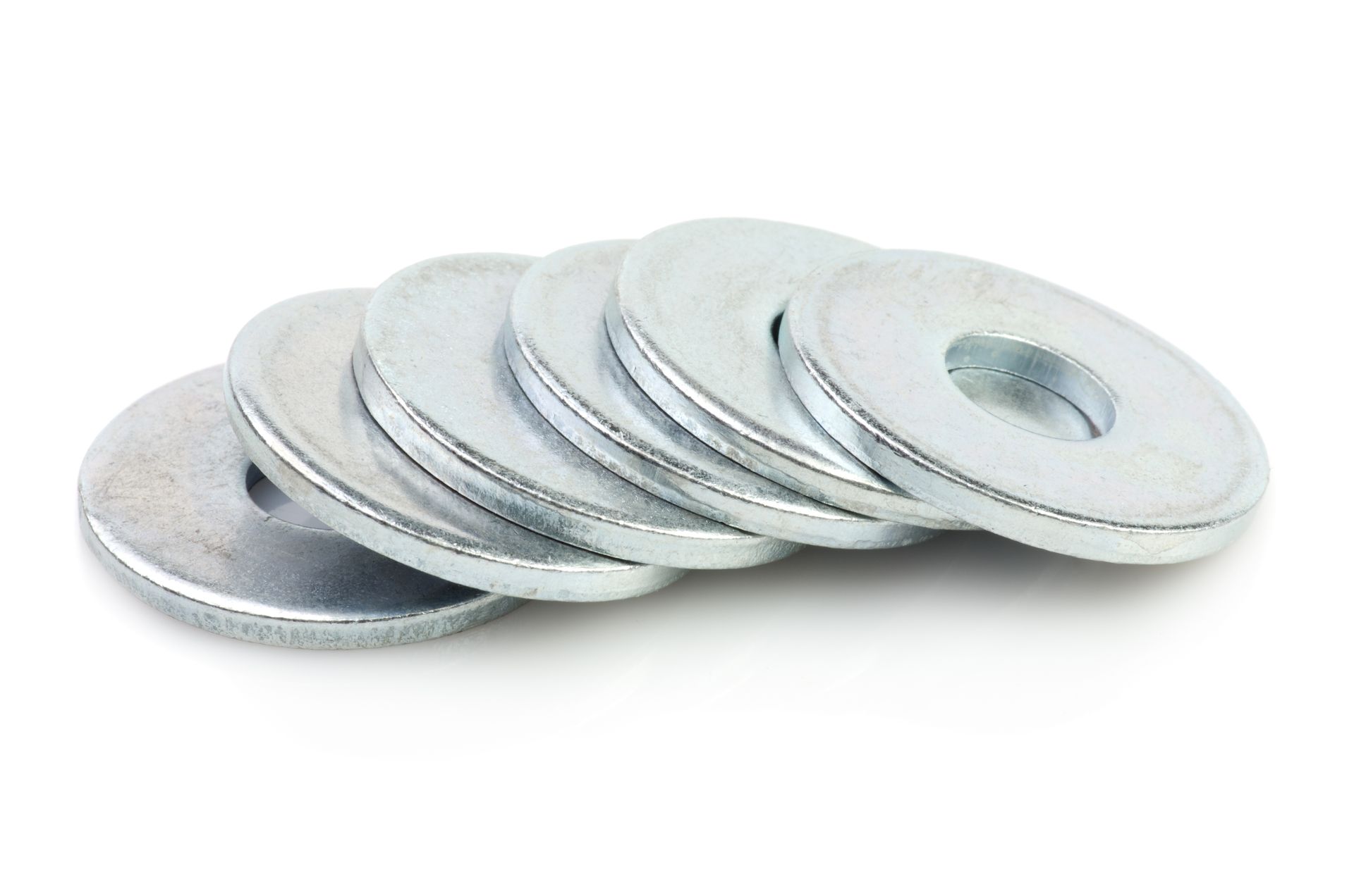Stack of silver metal washers on a white background