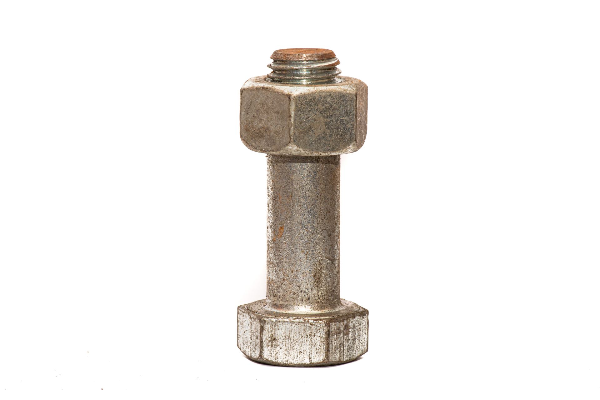 Rusty metal bolt standing upright on a white background
