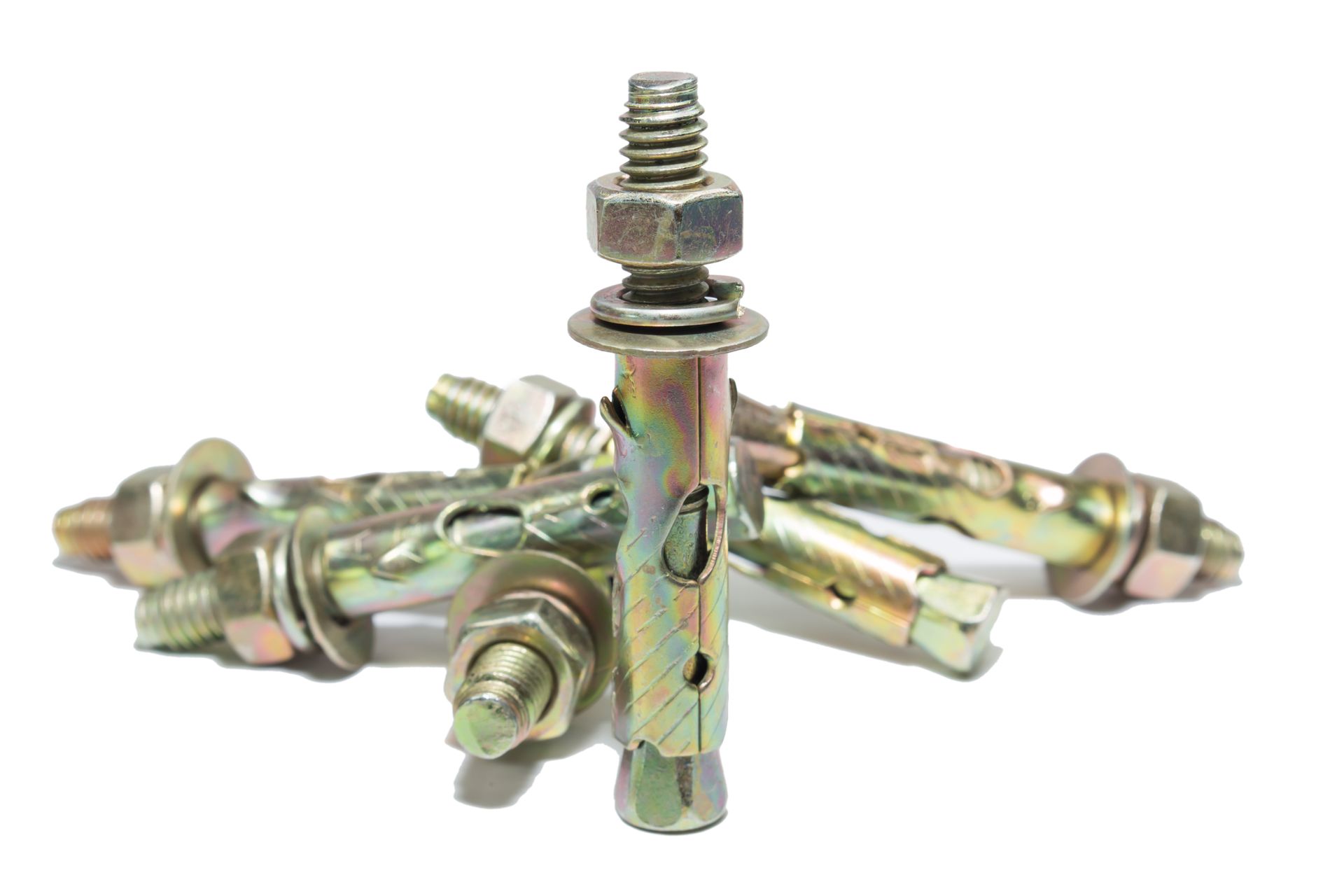 Metal expansion anchors and bolts arranged in a pile on a white background