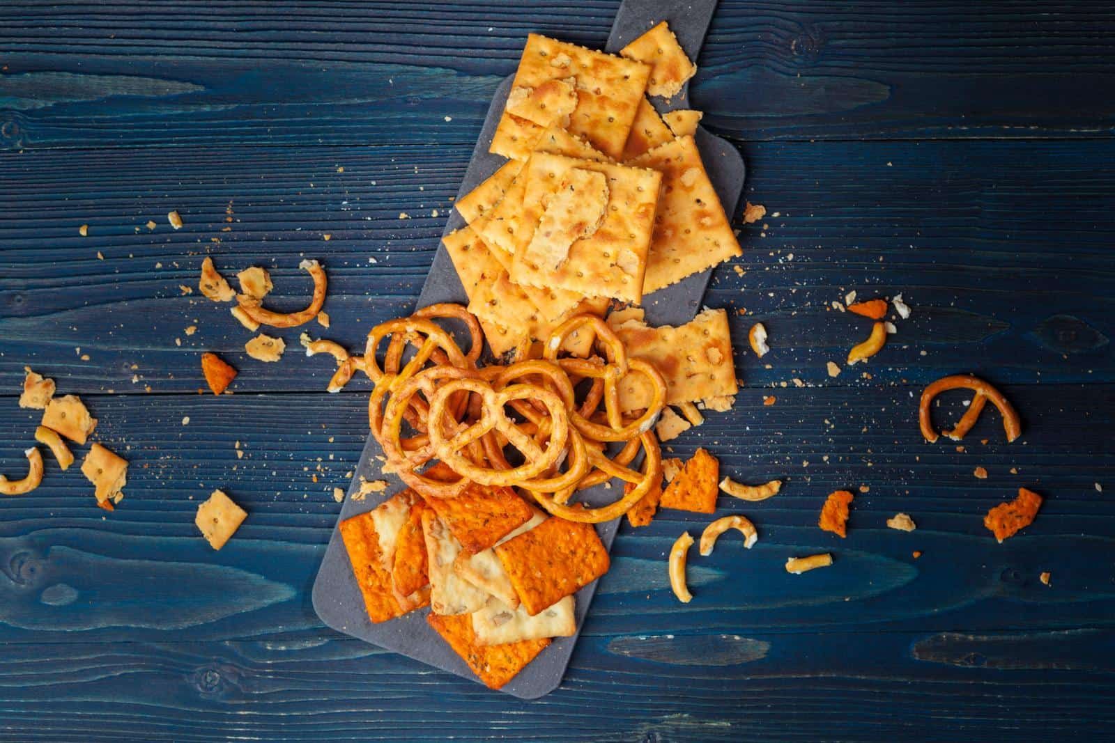 orange and yellow crackers on a wood board
