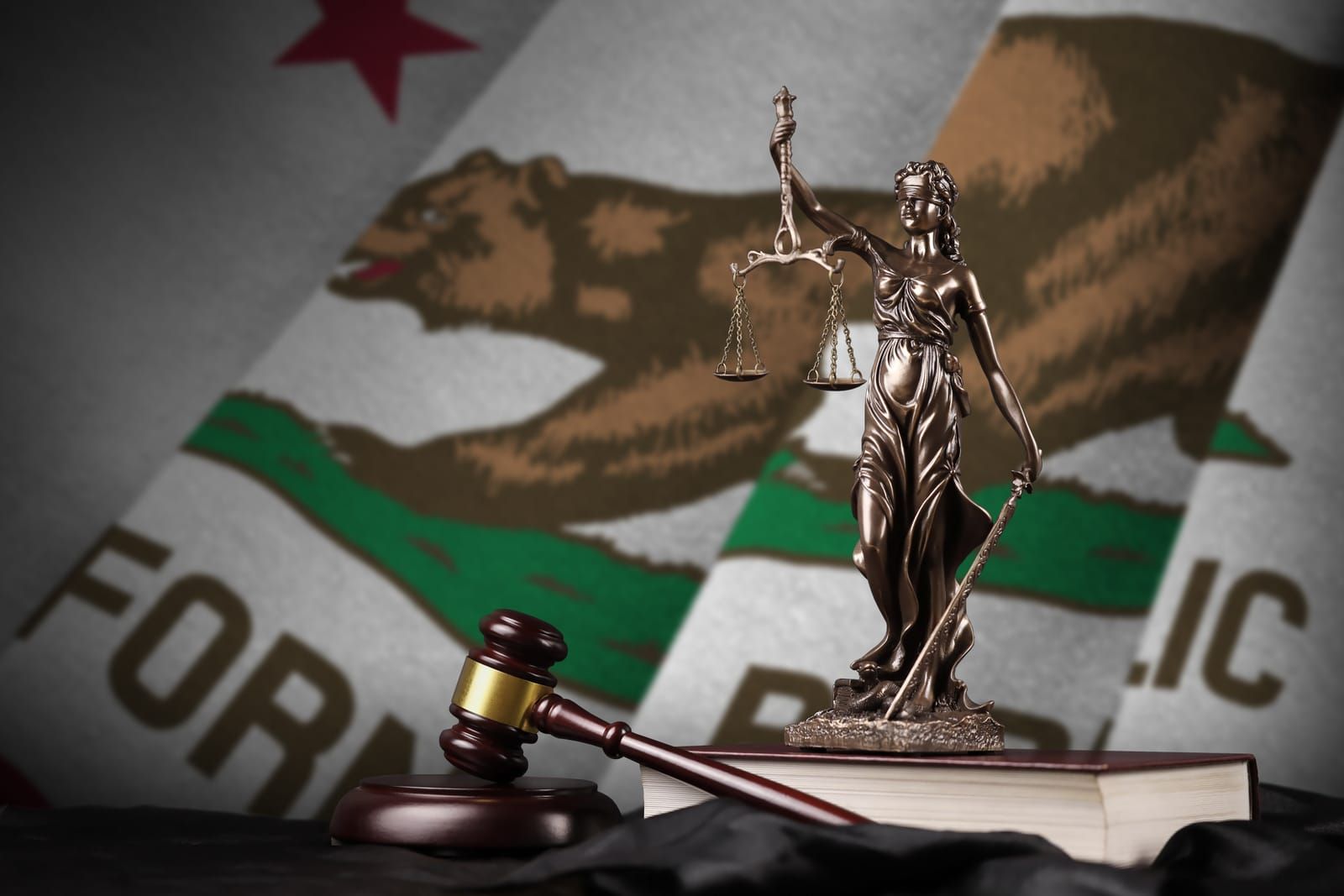 California US state flag with statue of lady justice, constitution and judge hammer on black drapery