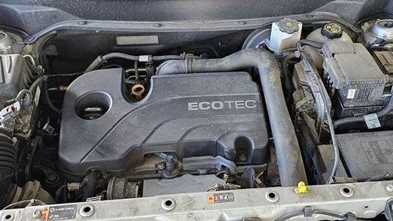 A close up of the engine of a car with the hood open.
