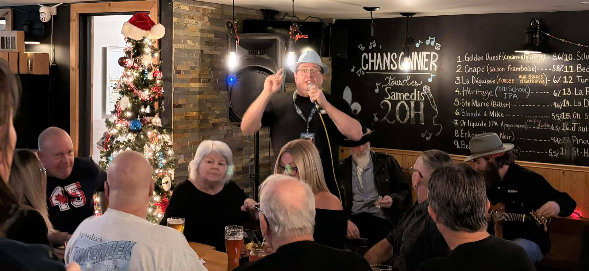 Man wearing a hat speaking in a microphone