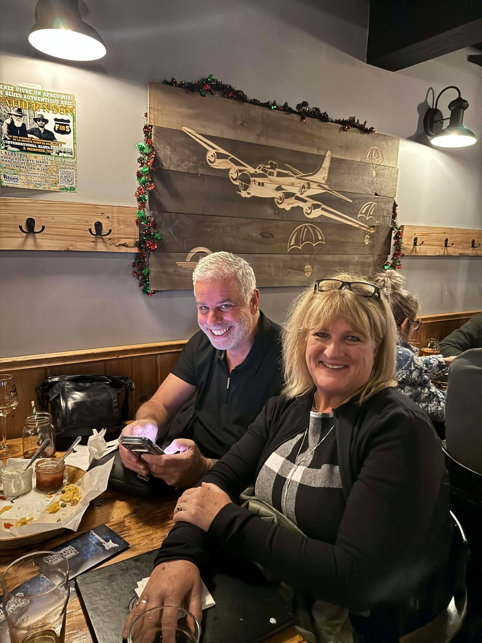Couple sitting at a table, smiling for the camera