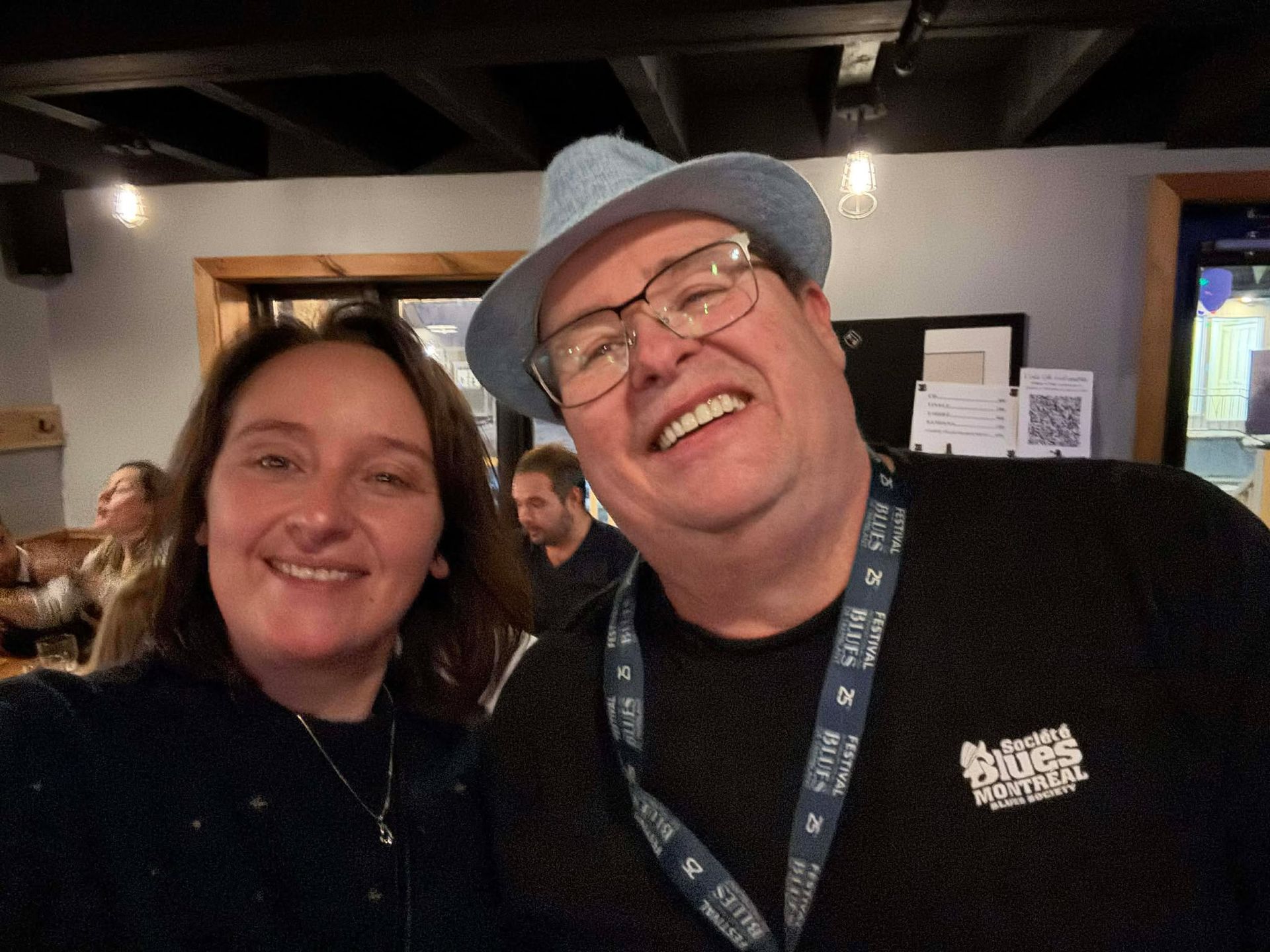 Man with blue hat and woman smiling for the camera
