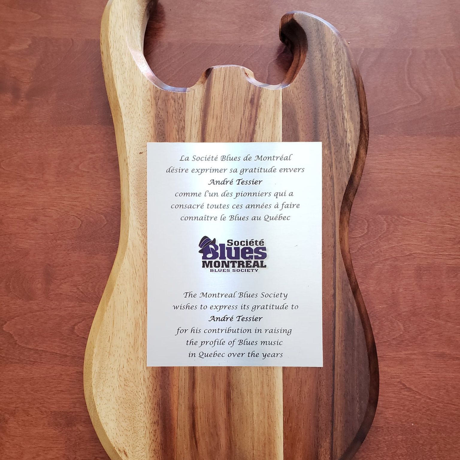 Plaque en forme de guitare honorant André Tessier pour sa contribution à la promotion du blues au Québec.