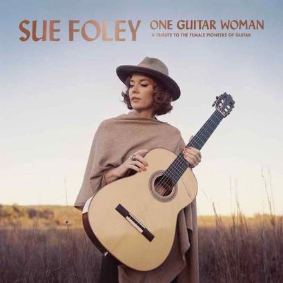 Sue Foley holding a guitar standing in a field for her album cover - One Guitar Woman