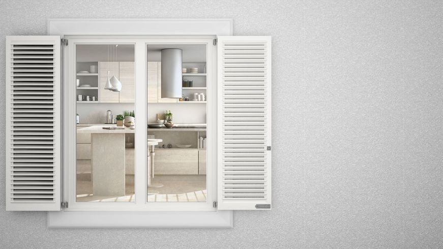 A kitchen is visible through a window with white shutters.