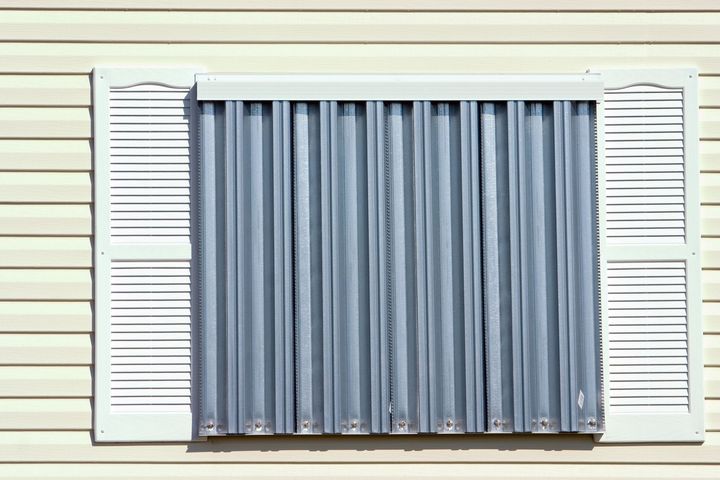 A row of windows with shutters on them on a building