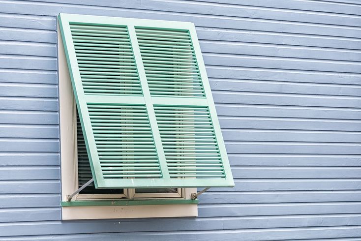 A window with green shutters.