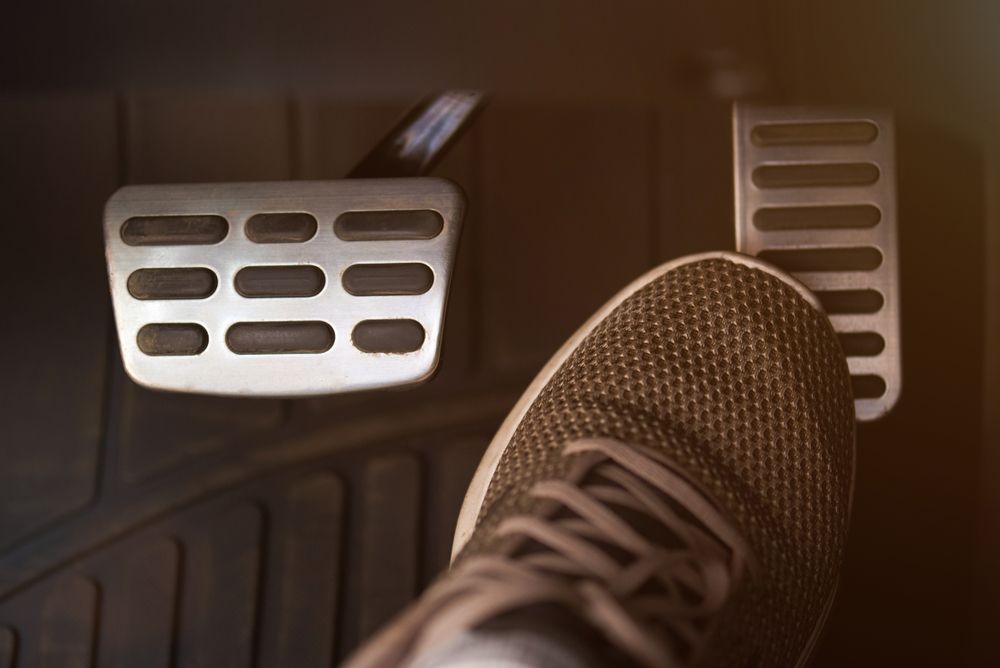 Foot Pressing Gas Pedal In A Car — Atherton Mechanical Services in Atherton, QLD