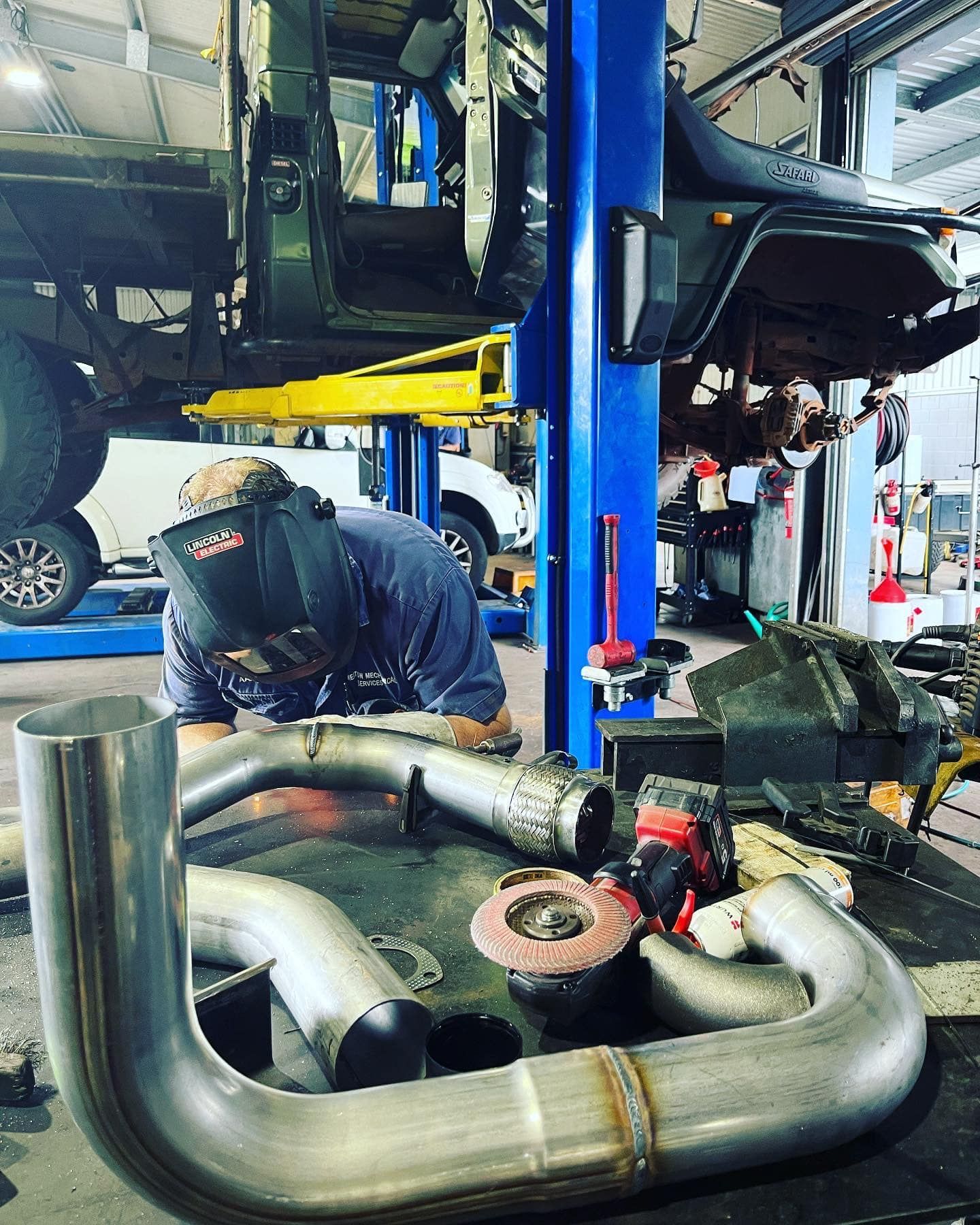 Underside View of a Black Car's Suspension System — Atherton Mechanical Services in Atherton, QLD