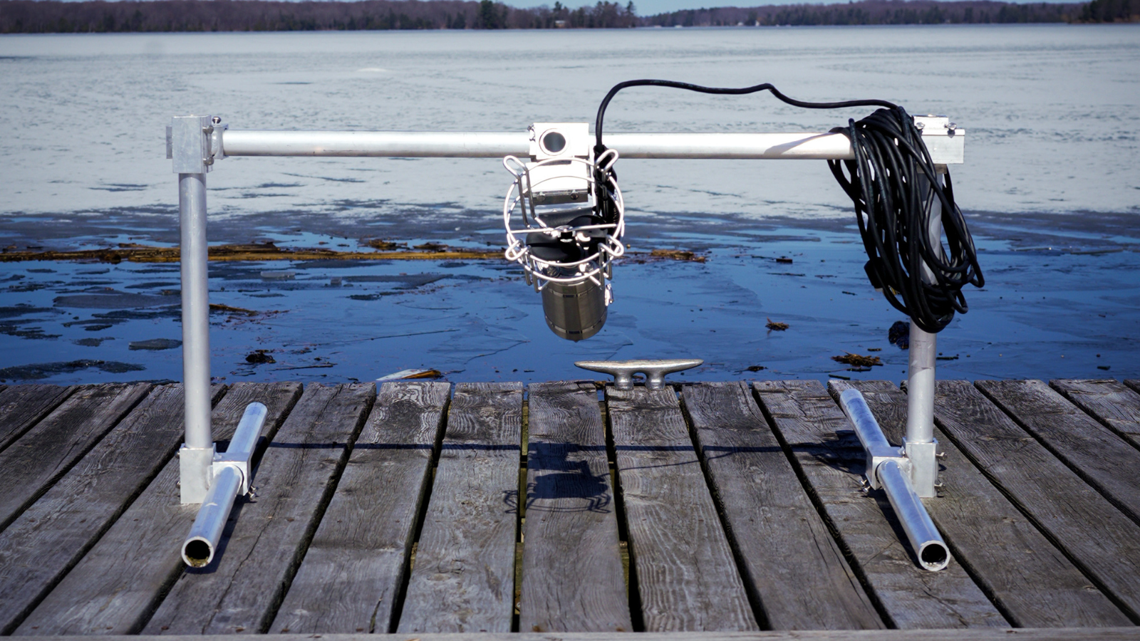 Dock-mounted water circulator and oscillator on a waterfront dock.