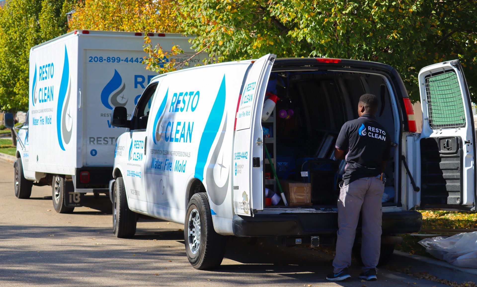 A man is standing in the back of a van that says best clean