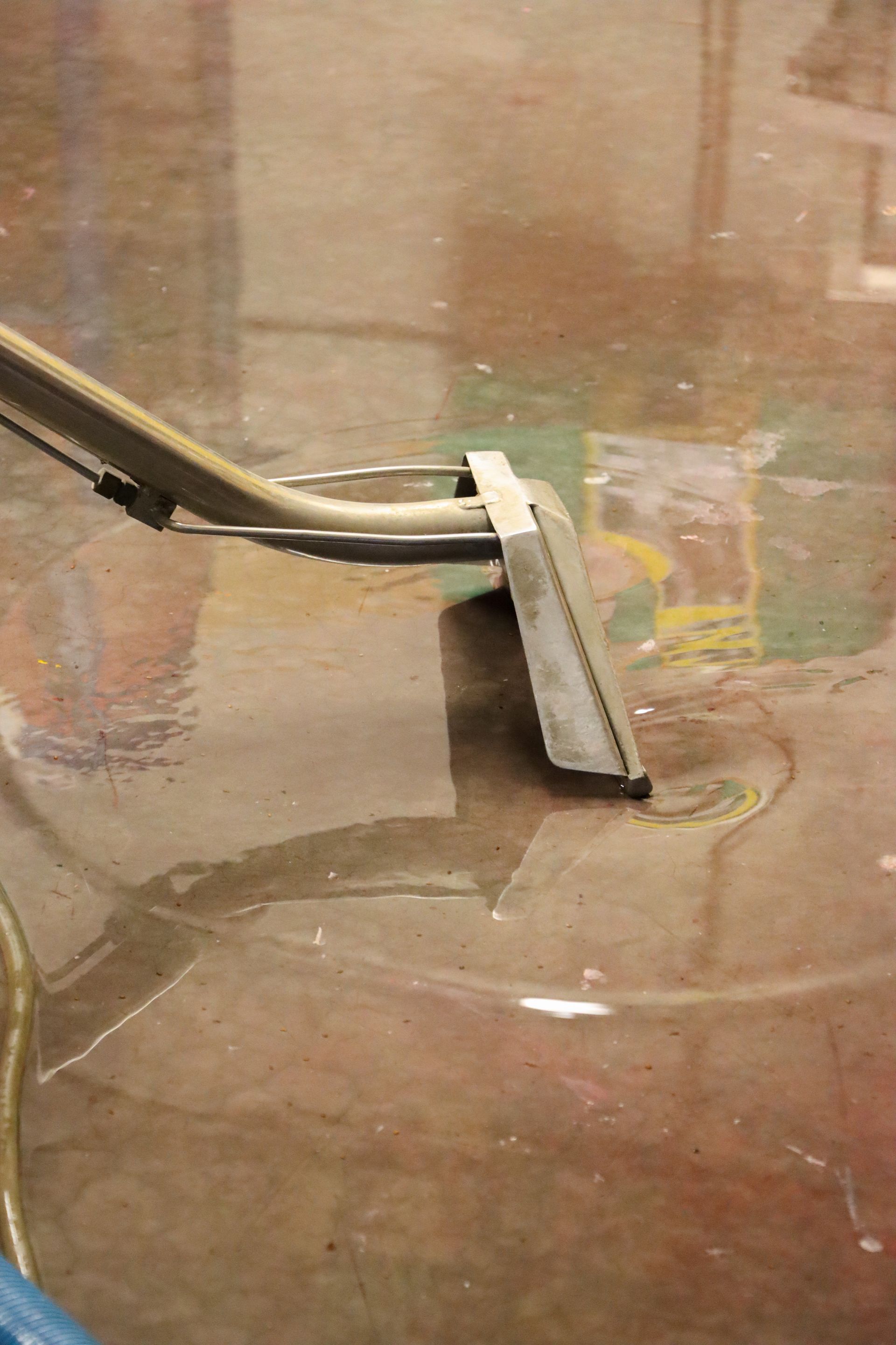 A vacuum cleaner is being used to clean a dirty floor.