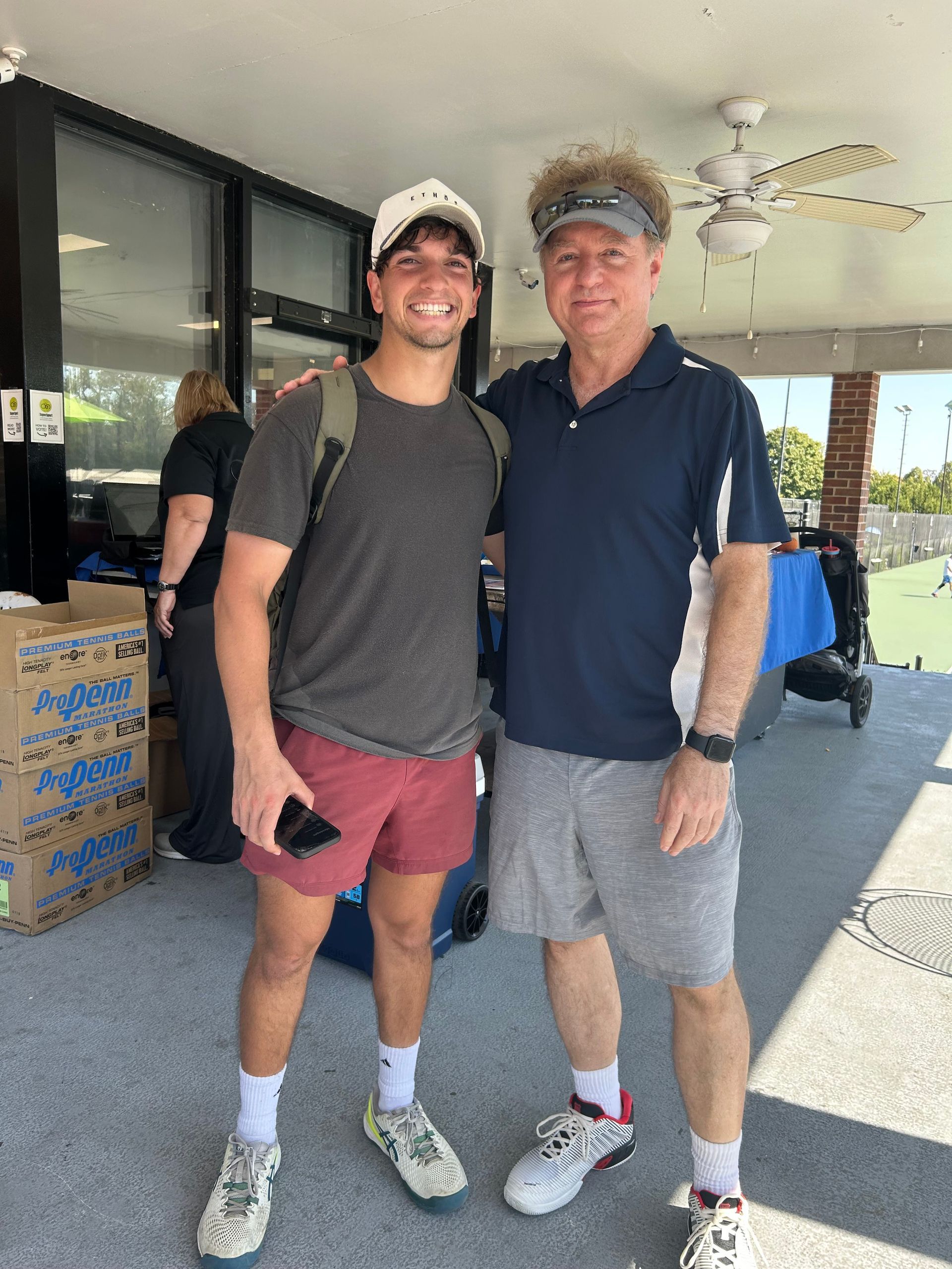 Tennis event participant Jibran Akhtar with a Gobi Grip inventor Dr. Mark Miller