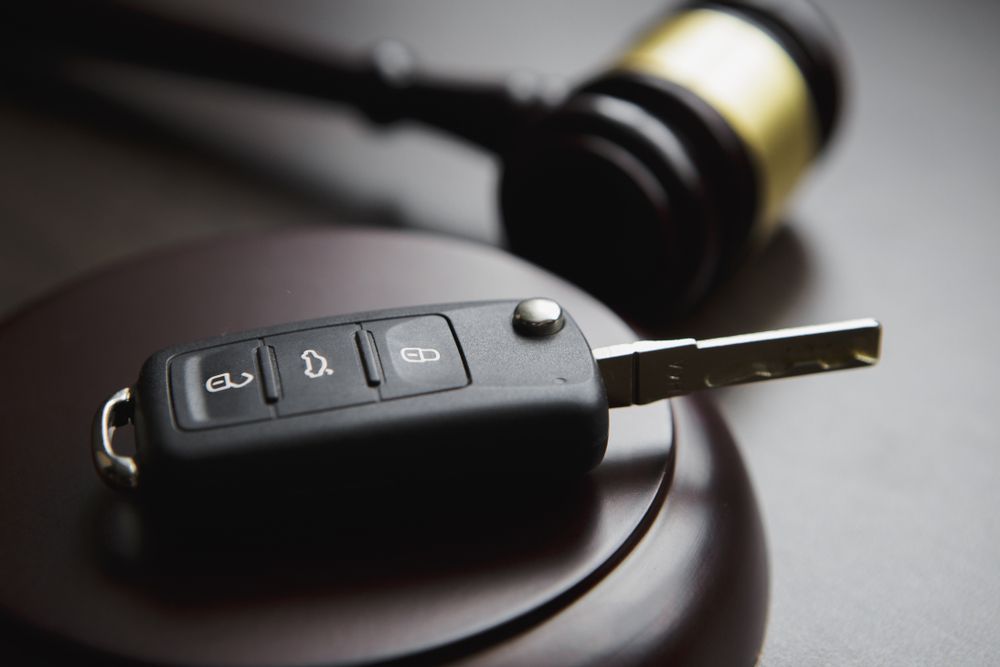 Car Key Fob on a Dark Surface With a Blurred Judge’s Gavel — Battery Assist Brisbane in Ascot, QLD