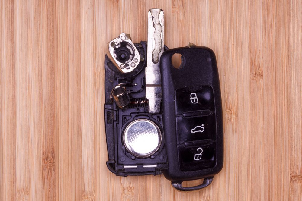 Car Key Fob Disassembled on a Wooden Surface — Battery Assist Brisbane in Geebung, QLD