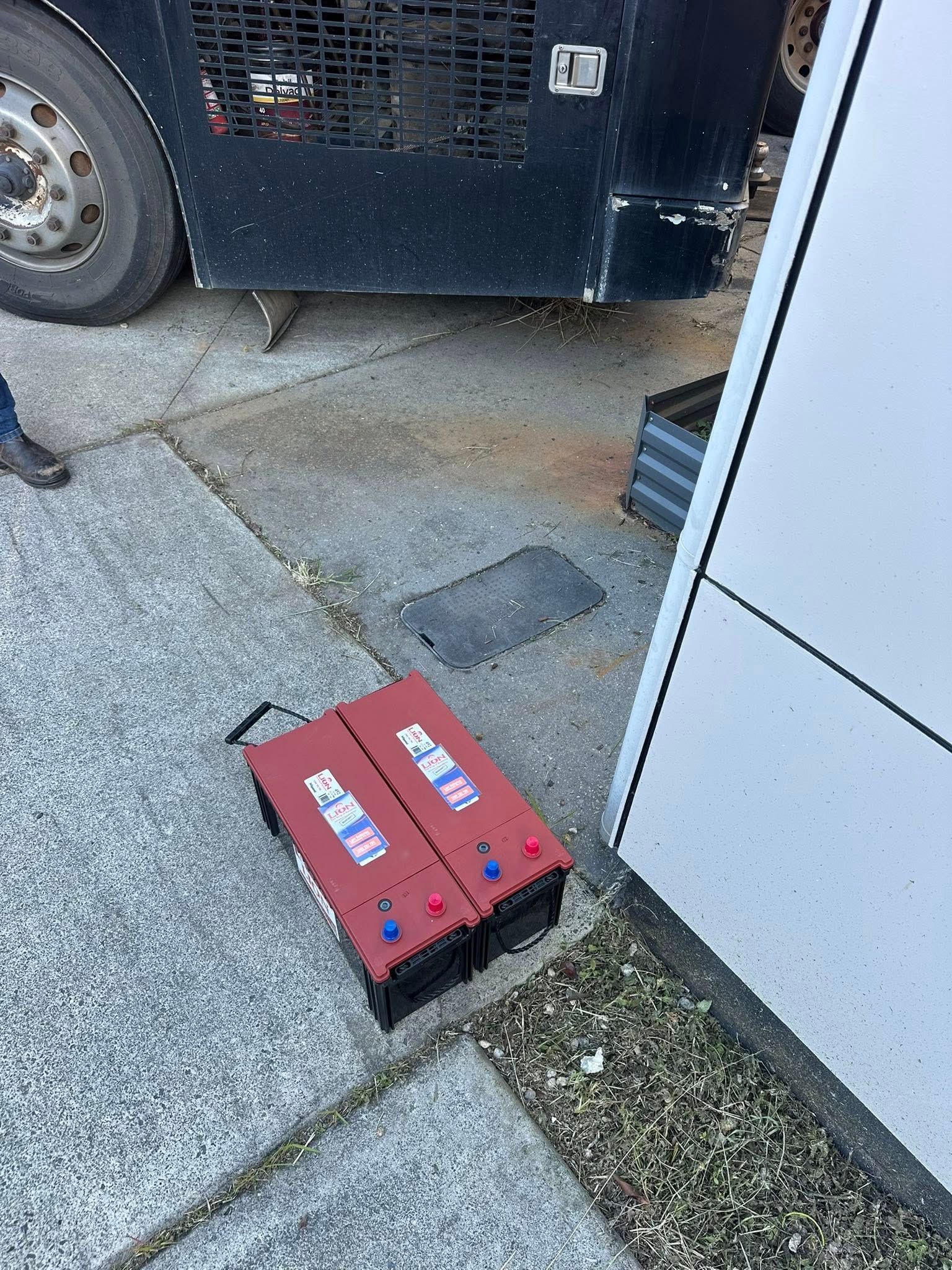 Red Tool Case on Sidewalk Beside a Truck Wheel — Battery Assist Brisbane in Geebung, QLD