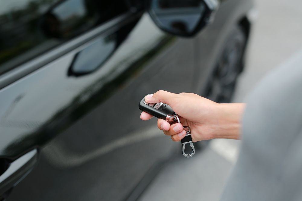Hand Holding Car Key Fob — Battery Assist Brisbane in Burpengary, QLD