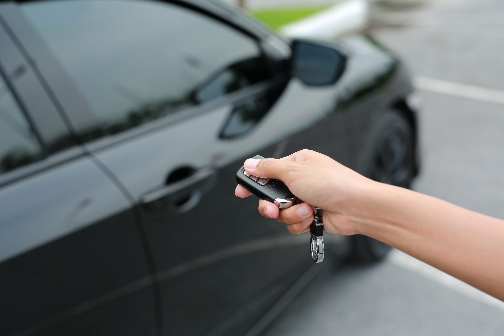 Hand Holding a Car Key Remote — Battery Assist Brisbane in Caboolture, QLD