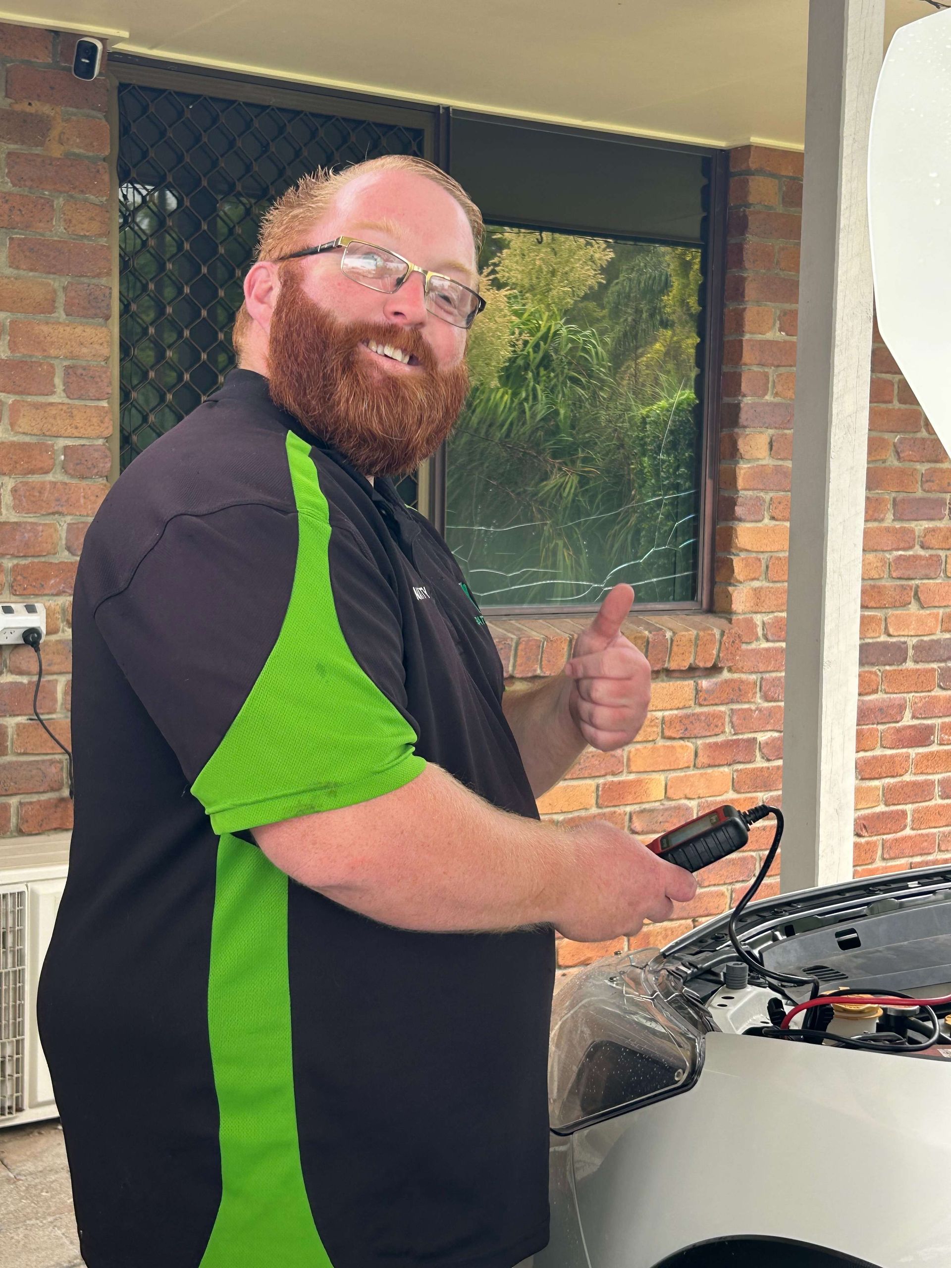 Mechanic Holding Device Near Car Engine, Giving Thumbs Up  — Battery Assist Brisbane in Caboolture, QLD
