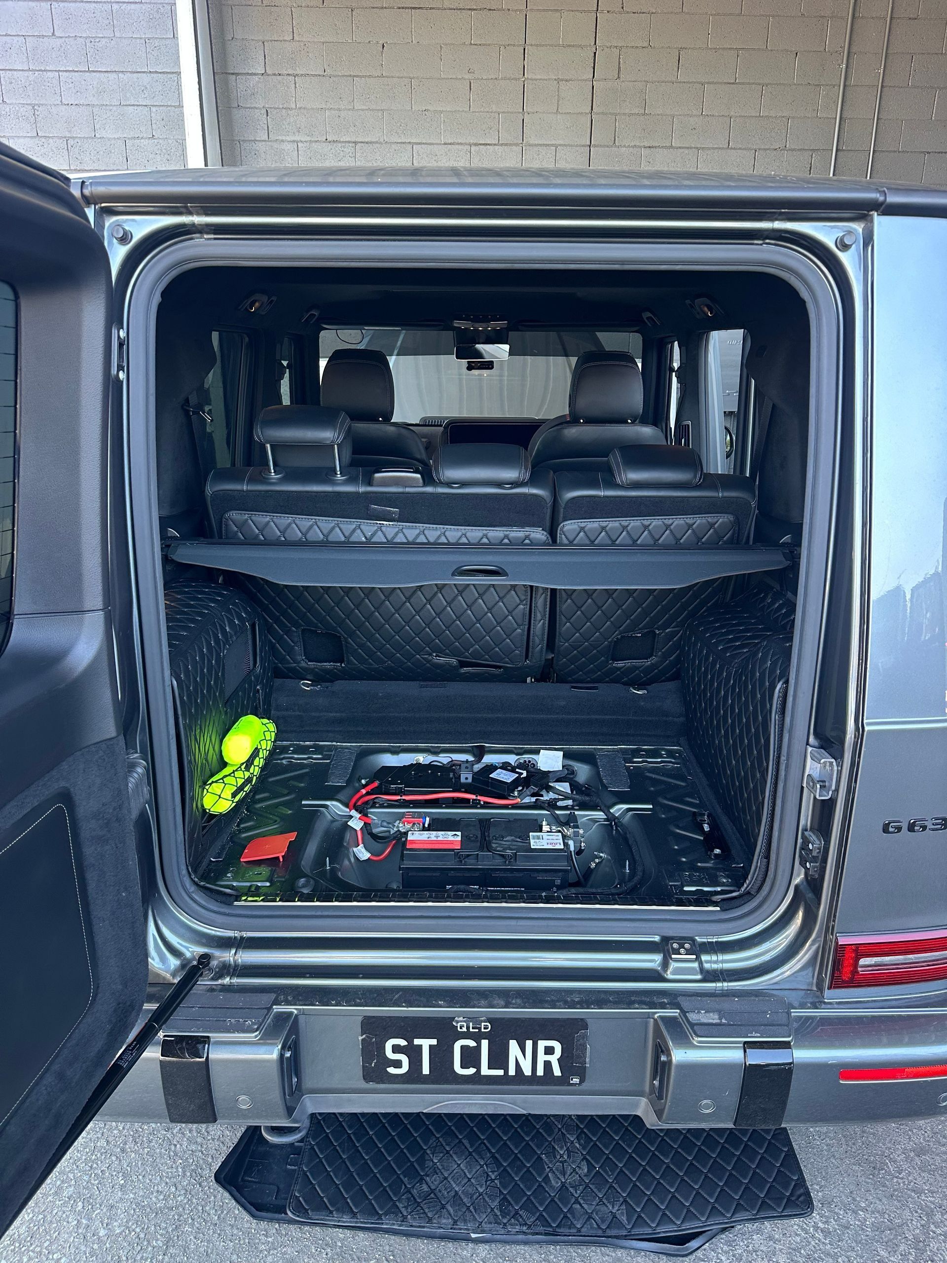 Open Rear Cargo Area of a Black SUV With Folded Seats — Battery Assist Brisbane in Warner, QLD