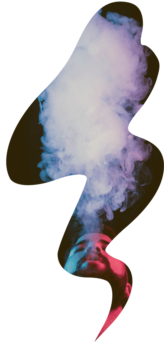 young bearded man smoking vape in dark studio with colored lights