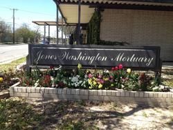 Jones Washington Mortuary sign in front of a flower bed and building exterior
