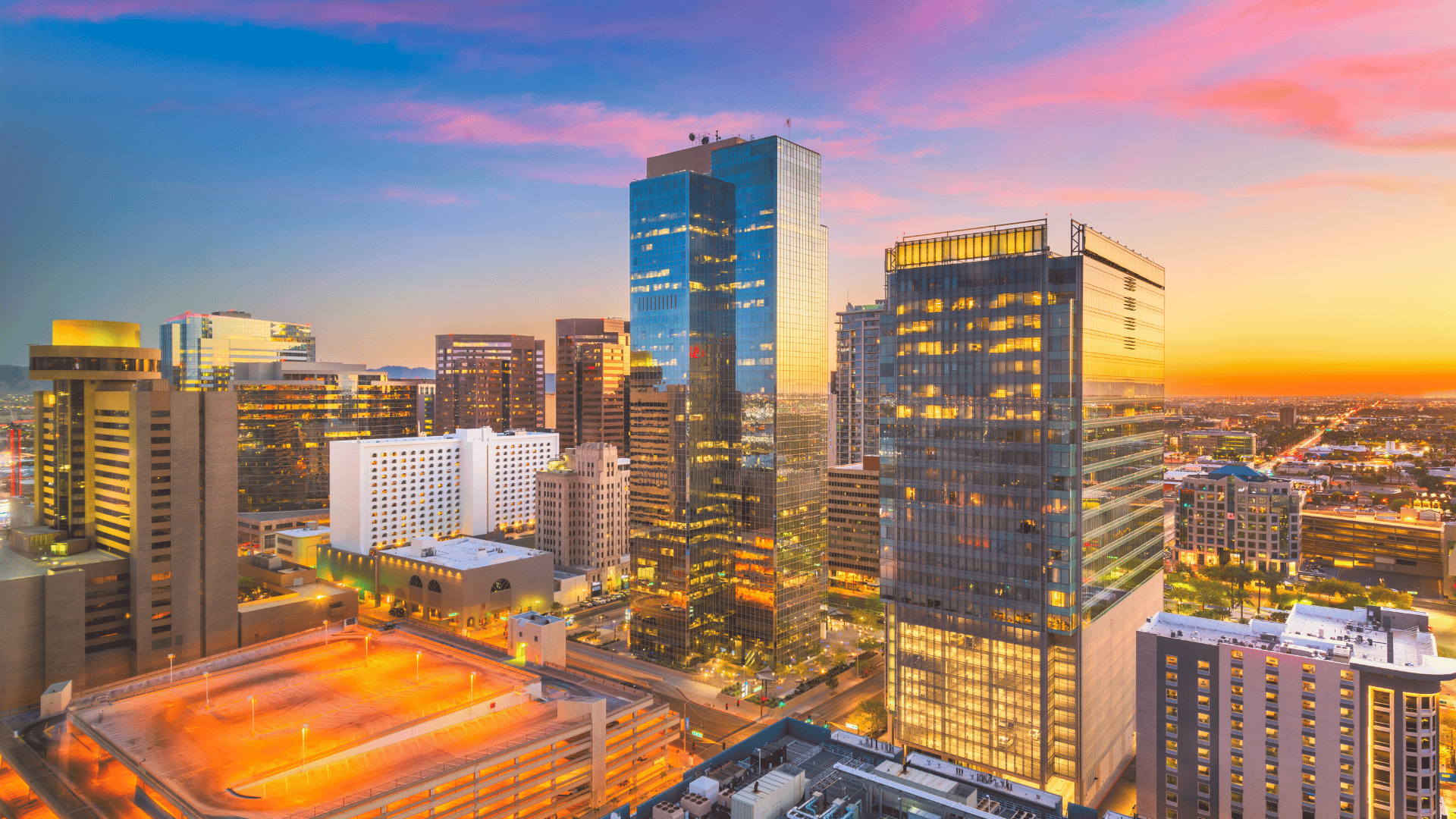 An aerial view of a city skyline at sunset.