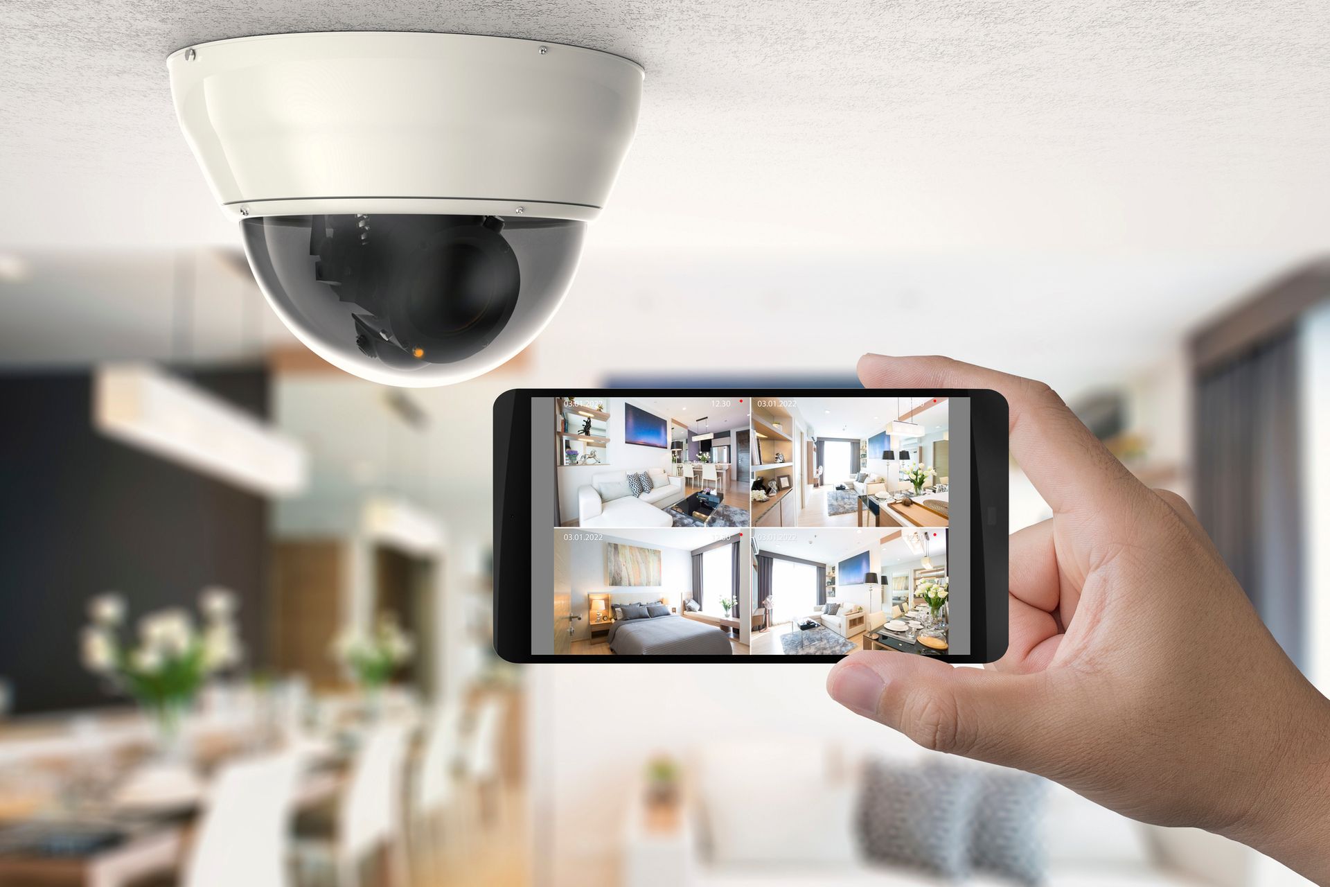 A hand holding a phone with a camera on the ceiling | Video Surveillance in Houston, TX