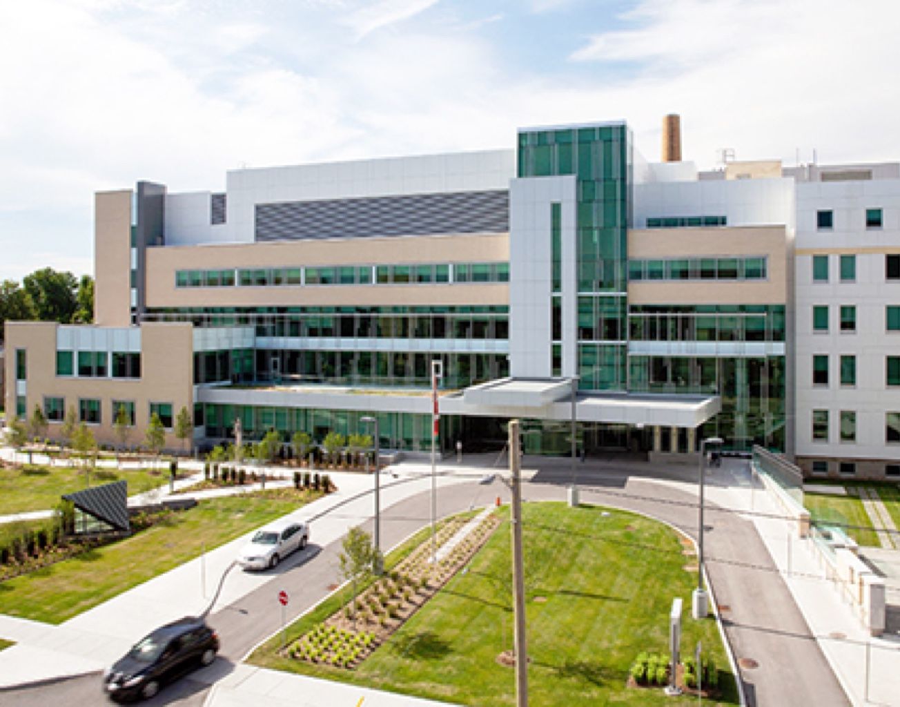A large building with a lot of windows and a car parked in front of it.