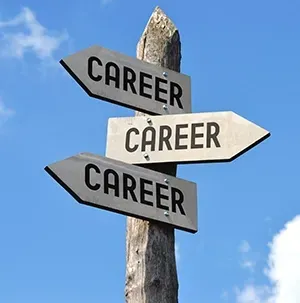 Three directional signs on a post, each labeled “CAREER,” against a blue sky.