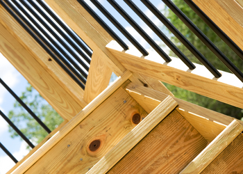 wooden deck stairs with metal railing