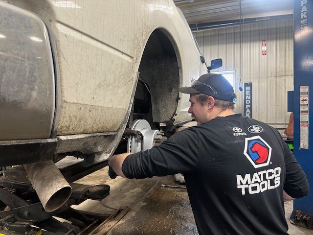 Mechanic inspecting brakes