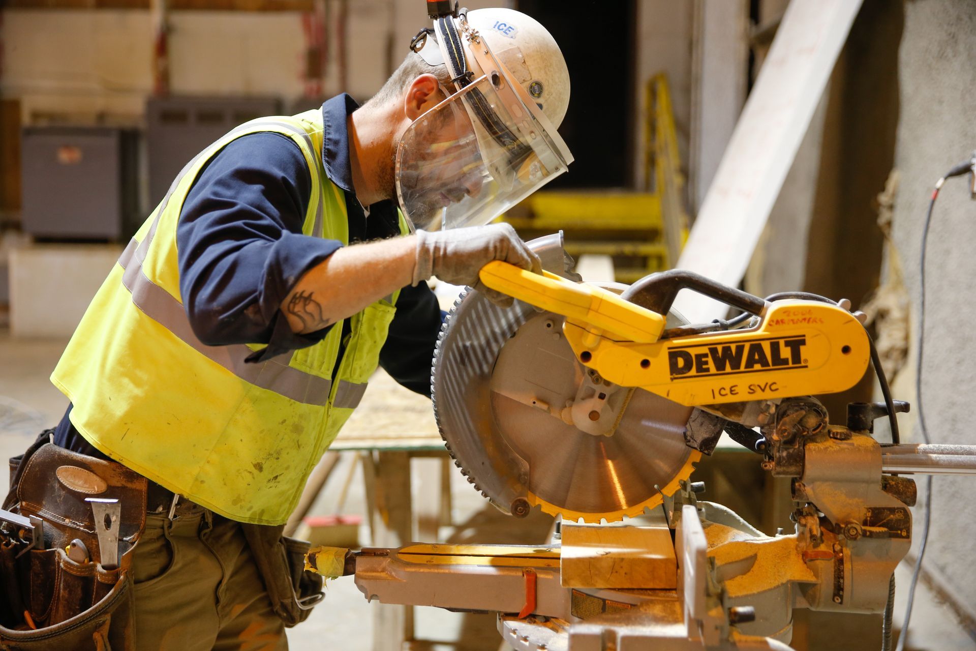 A man is using a dewalt circular saw to cut a piece of wood.