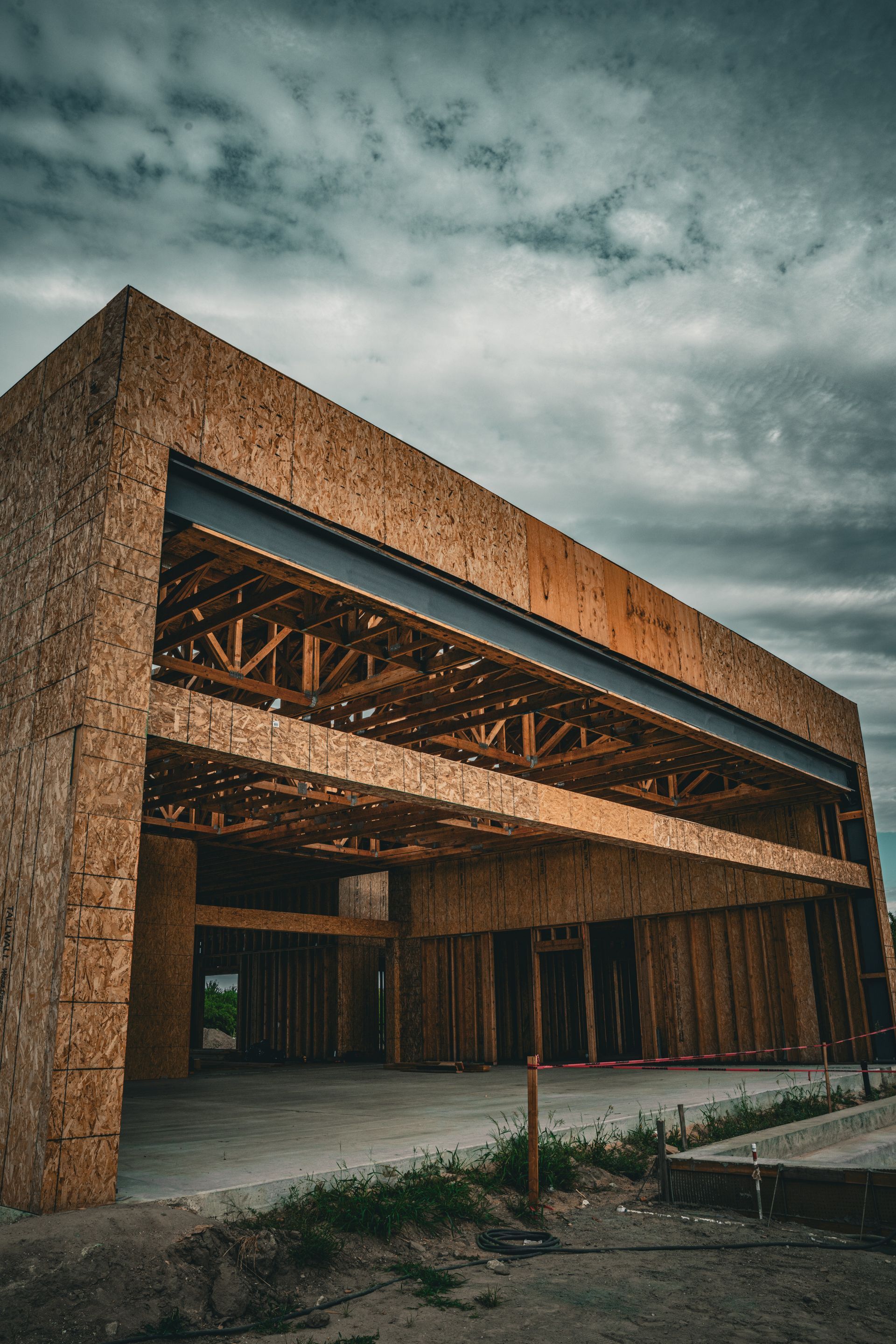 Large warehouse with metal storage racks and stacked cardboard boxes under bright lights