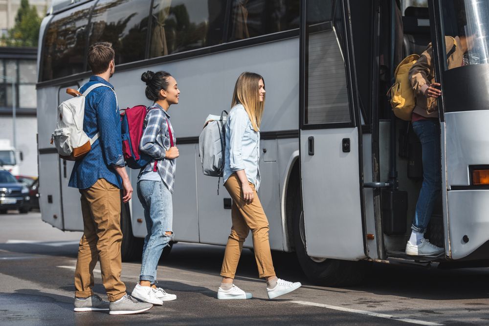 Group of People Walking Into Bus — Cotswold Hills, QLD — Robertson's Bus & Coaches