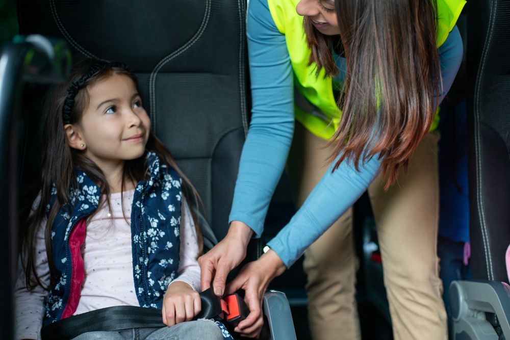 Putting Seatbelt on Student — Cotswold Hills, QLD — Robertson's Bus & Coaches